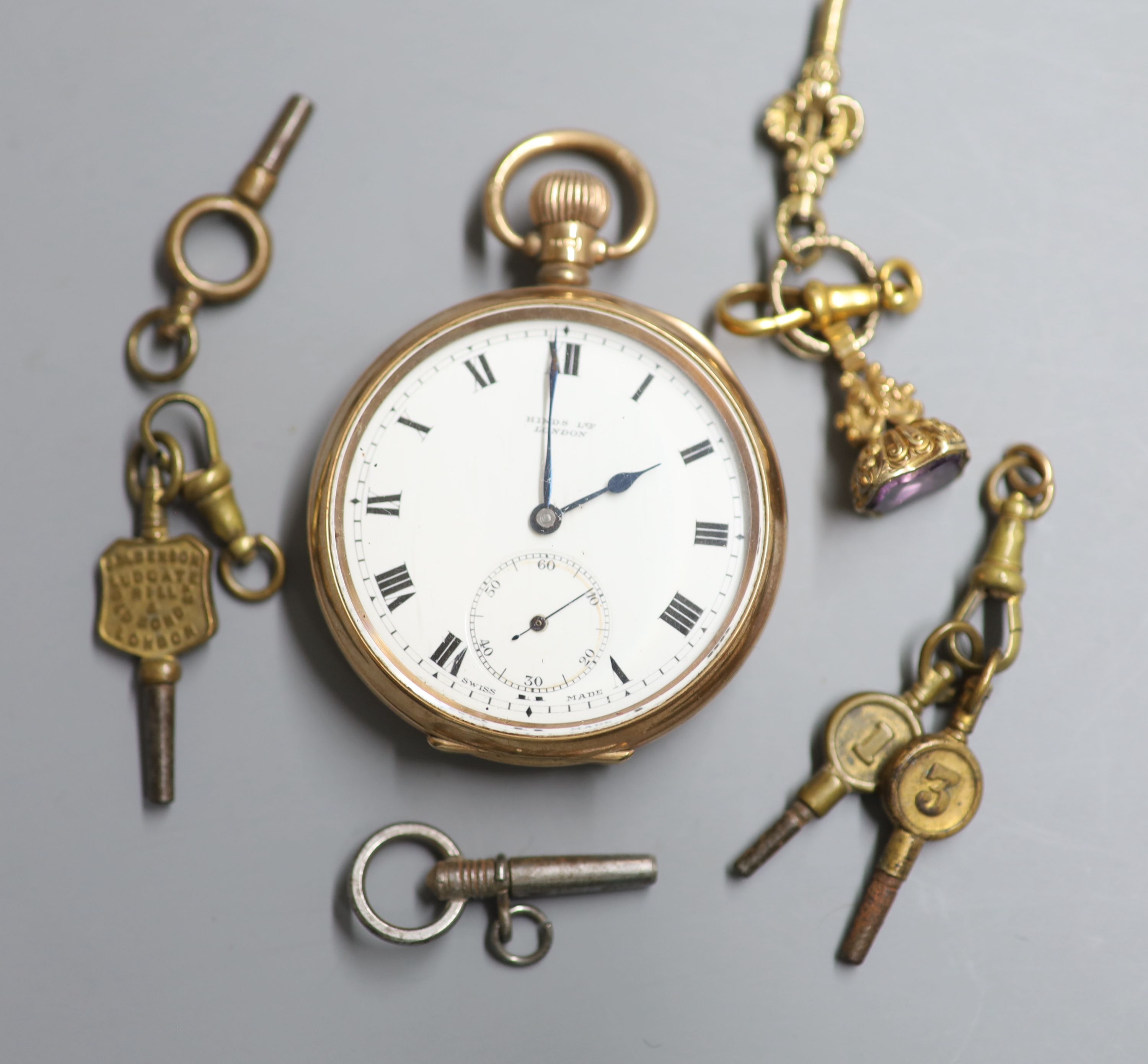 A George V 9ct gold open faced keyless lever pocket watch, retailed by Hinds Ltd, London, six watch keys and a gem set fob seal,